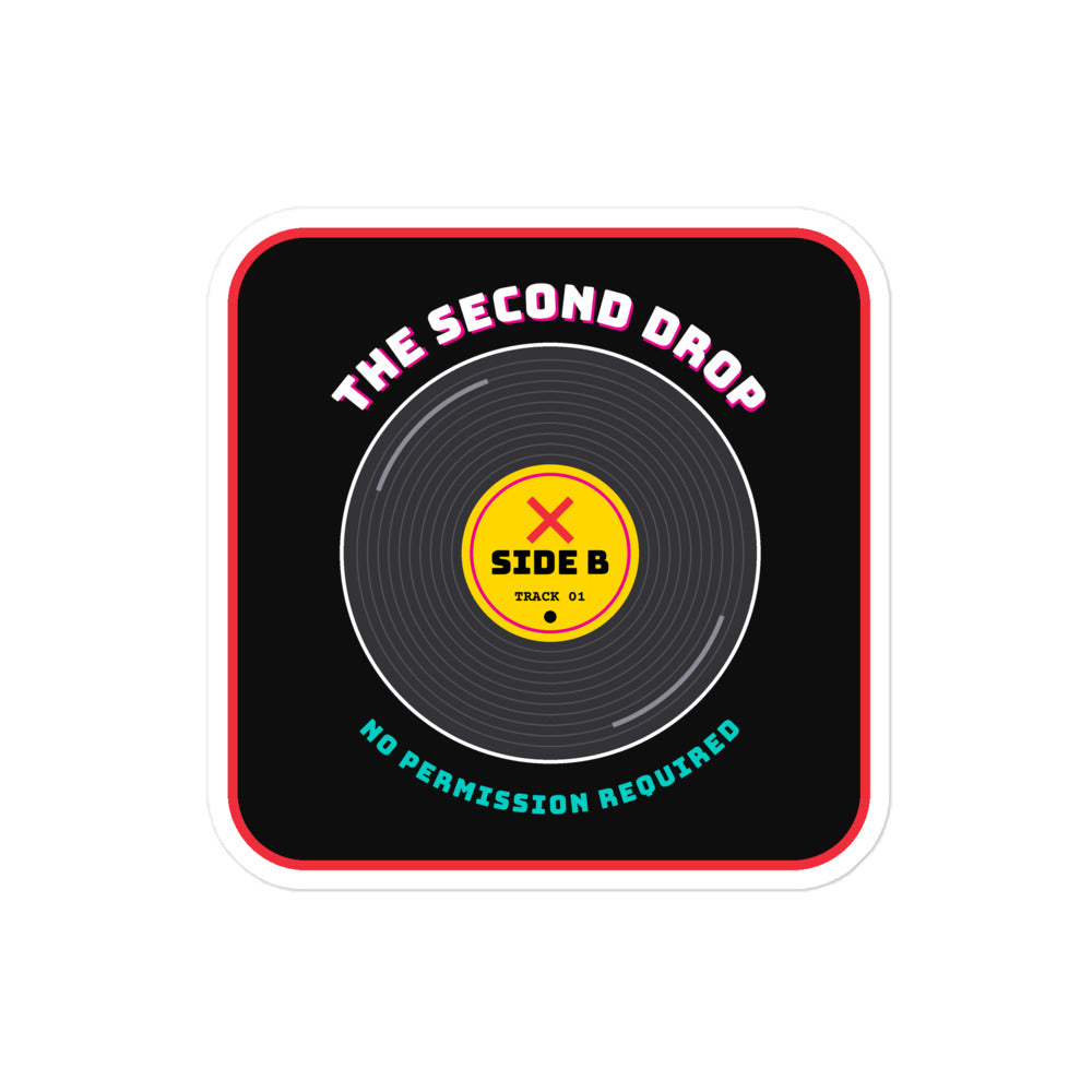 A square sticker or decal with rounded corners featuring a vinyl record graphic on a black background. The design includes the text 'THE SECOND DROP' in pink at the top, a yellow center label reading 'SIDE B' with a red X, and 'NO PERMISSION REQUIRED' in teal at the bottom.