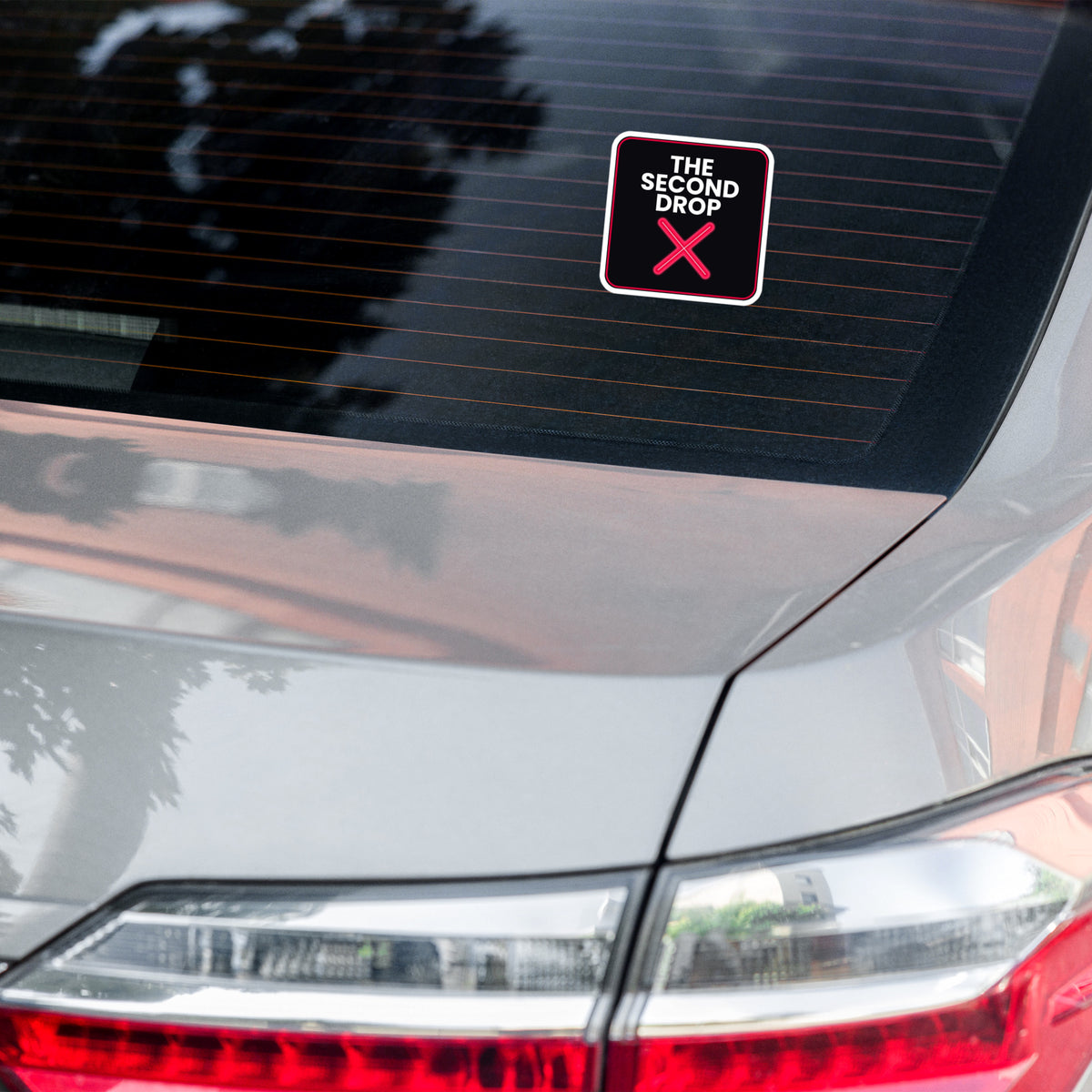 The Second Drop with red X -a decorative sticker on a car window