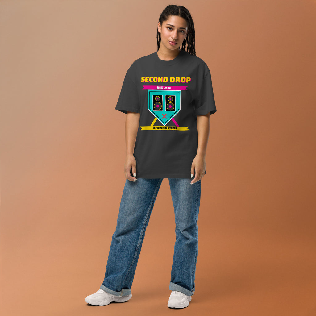 Person wearing a black t-shirt with a graphic design The Second Drop on a brown background