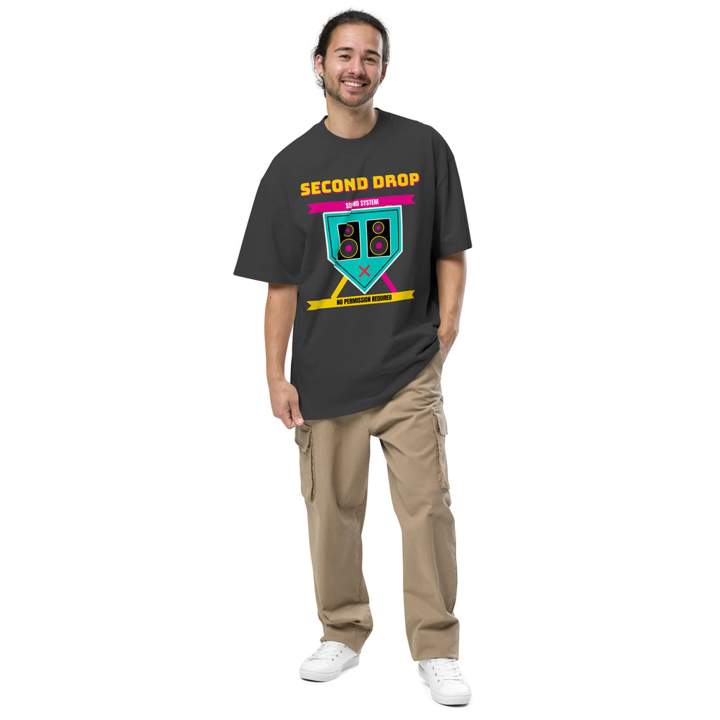 A man modeling a dark charcoal gray t-shirt with a blue starfish graphic and the text 'The Second Drop' on the chest, paired with tan cargo pants and white sneakers, against a plain white background.