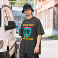 Man wearing a black t-shirt with a graphic design standing next to a vehicle.
