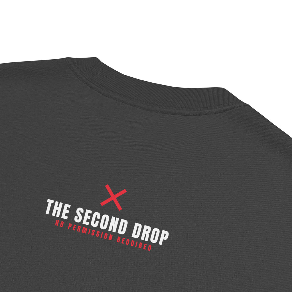 Close-up of the back of a dark charcoal gray t-shirt featuring a red 'X' logo and the text 'THE SECOND DROP' and 'NO PERMISSION REQUIRED' in white and red.