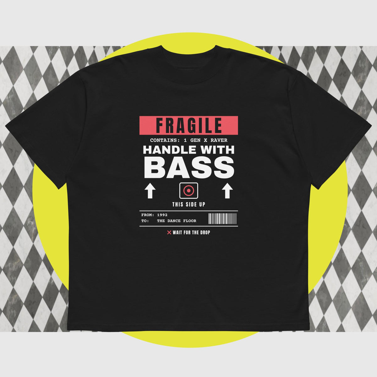 A black short-sleeve graphic t-shirt displayed flat against a stylized background. The graphic features a red and white barcode-style design with the text 'FRAGILE HANDLE WITH BASS'.